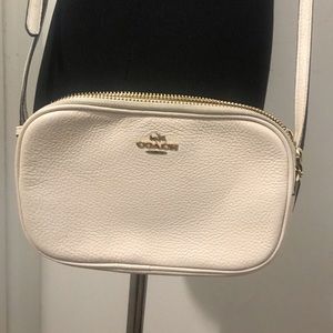 White small COACH crossbody bag.